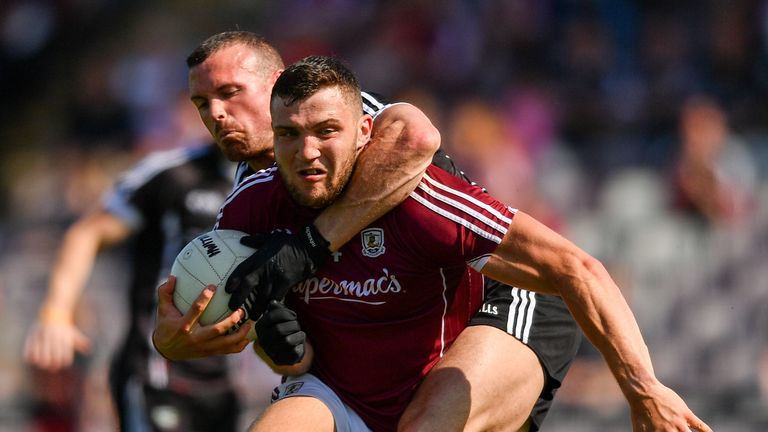 Damien Comer of Galway is tackled by Eoin McHugh of Sligo