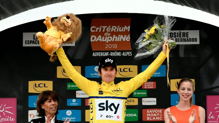 Britain's Geraint Thomas, wearing the overall leader's yellow jersey, celebrates on the podium after the sixth stage of the 70th edition of the Criterium du Dauphine cycling race between Frontenex and La Rosiere on June 9, 2018. 
