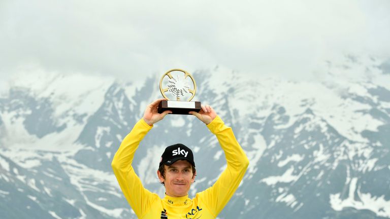 Overall race winner Britain's Geraint Thomas, wearing the overall leader's yellow jersey, celebrates with his trophy after the seventh and last stage of the 70th edition of the Criterium du Dauphine cycling race between Moutiers and Saint-Gervais Mont-Blanc