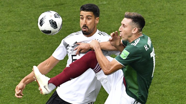 Hector Herrera competes for the ball with Sami Khedira