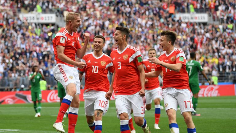 Yury Gazinsky celebrates with teammates after scoring the opening goal against Saudi Arabia