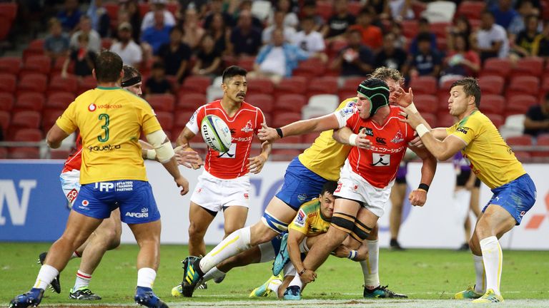 James Moore of the Sunwolves offloads as he is tackled by RG Snyman