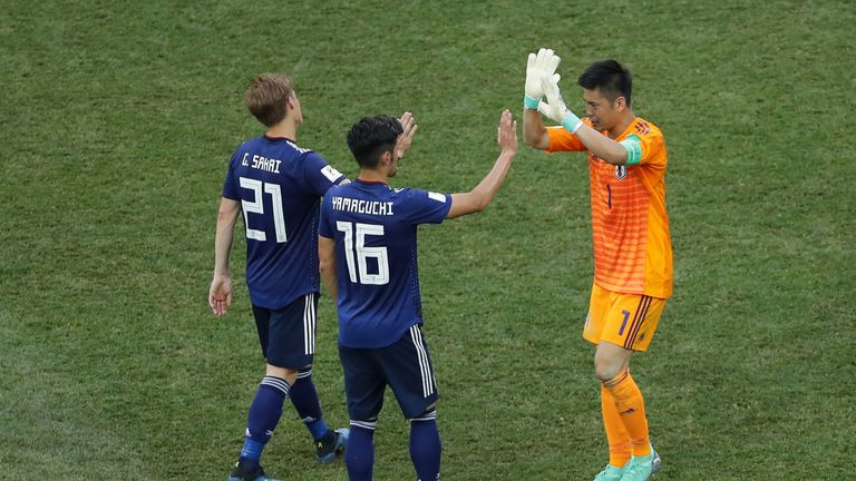Gotoku Sakai, Hotaru Yamaguchi and Eiji Kawashima of Japan celebrate following the 2018 FIFA World Cup Russia group H match between Japan and Poland at Volgograd Arena on June 28, 2018