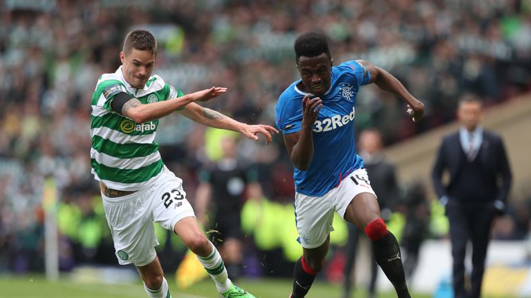 Mikael Lustig of Celtic vies with Joe Dodoo of Rangers 