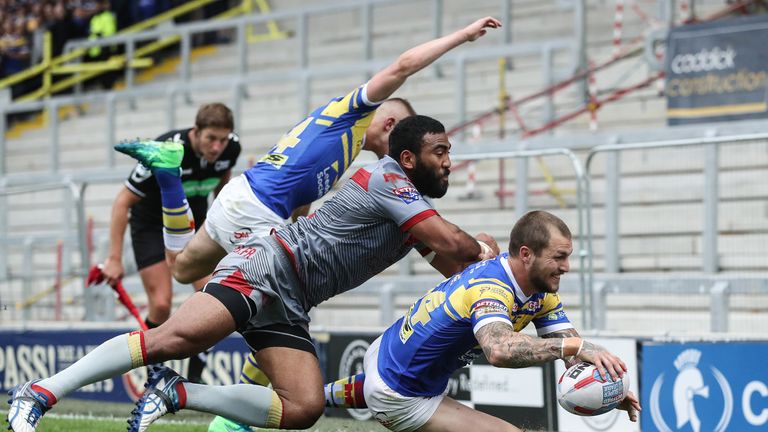 Leeds Rhinos Luke Briscoe goes over for a try past Catalans Dragons' Samisoni Langi