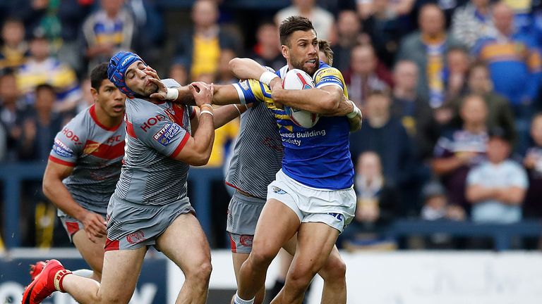 Leeds Rhinos Joel Moon is tackled by Catalans Dragons' Benjamin Jullien and Lewis Tierney