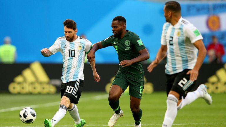 Lionel Messi of Argentina is challenged by Nigeria's Bryan Idowu