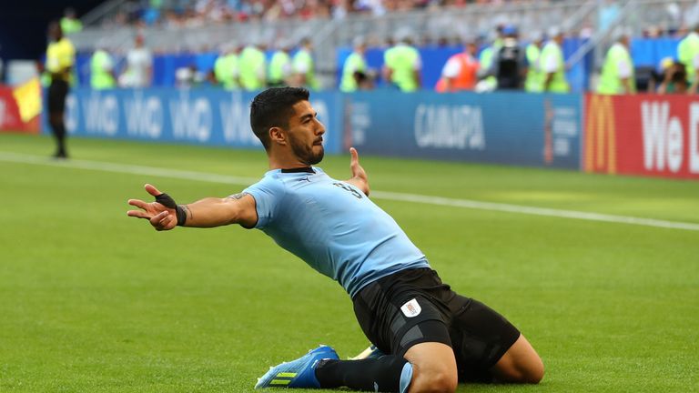 Luis Suarez drops to his knees in celebration after giving Uruguay the lead