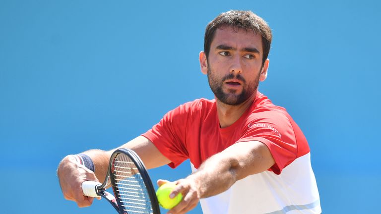 Croatia's Marin Cilic serves to Serbia's Novak Djokovic during the men's singles final at the ATP Queen's Club Championships tennis tournament in west London on June 24, 2018. 
