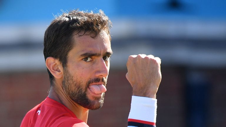 Croatia's Marin Cilic celebrates taking the second set against Serbia's Novak Djokovic during the men's singles final at the ATP Queen's Club Championships tennis tournament in west London on June 24, 2018.