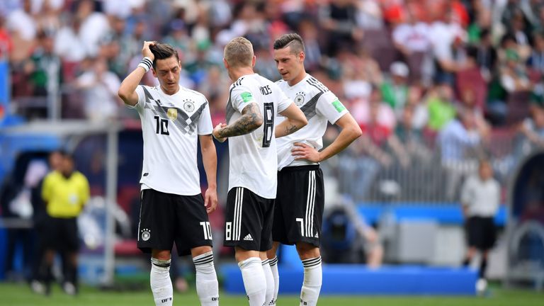 Mesut Ozil, Toni Kroos and Julian Draxler in discussion prior to a Germany free kick