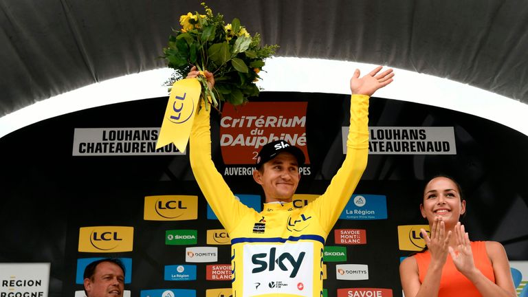 Poland's Michal Kwiatkowski, wearing the overall leader's yellow jersey, celebrates on the podium after Great Britain's Sky cycling team won the third stage of the 70th edition of the Criterium du Dauphine cycling race, a 35-kilometer team time trial between Pont-de-Vaux and Louhans, central eastern France, on June 6, 2018. (Photo by Philippe LOPEZ / AFP) (Photo credit should read PHILIPPE LOPEZ/AFP/Getty Images)