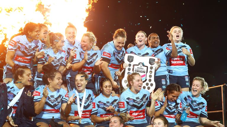 The Blues celebrate with the shield after victory during the Women's State of Origin match between New South Wales and Queensland