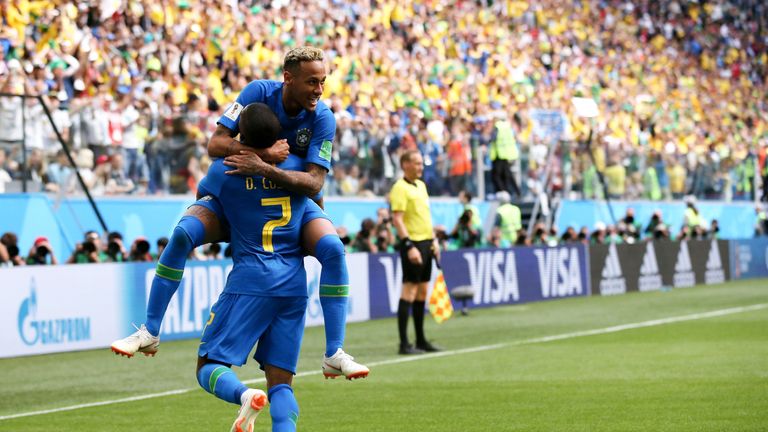 Neymar celebrates with Douglas Costa after scoring Brazil's second goal