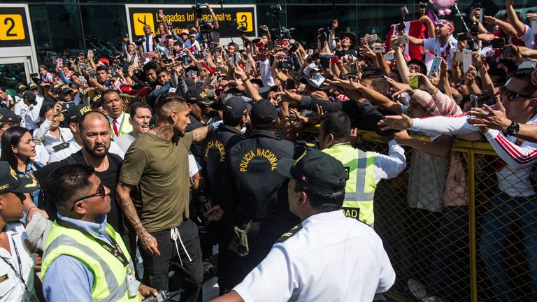 Peru's national football team captain Paolo Guerrero (C) is greeted by supporters as he arrives at the Jorge Chavez airport in Lima on May 15, 2018 a day after the Court of Arbitration for Sport (CAS) increased a previous sanction by imposing a 14-month doping ban on him