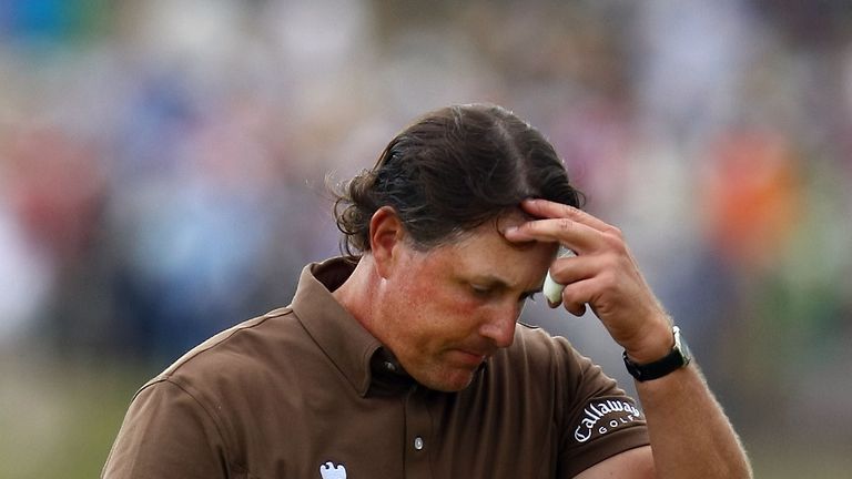Phil Mickelson walks off the 18th green during the continuation of the final round of the 109th US Open