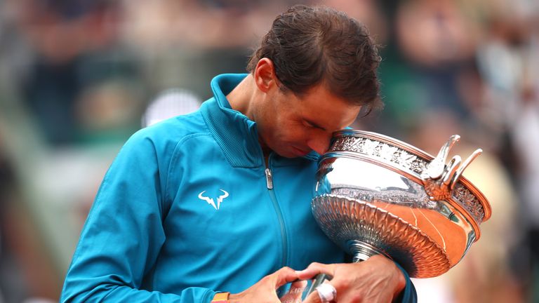 Rafael Nadal of Spain hugs the Musketeers' Cup as he celebrates victory following the mens singles final against Dominic Thiem of Austria during day fifteen of the 2018 French Open at Roland Garros on June 10, 2018 in Paris, France.