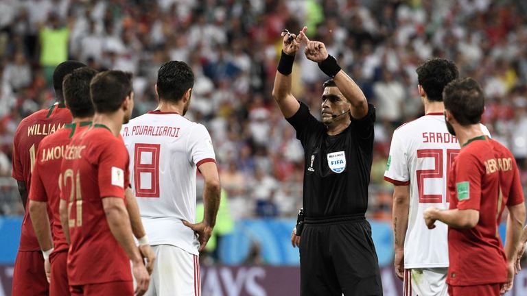 The referee calls for VAR during Portugal's clash with Morocco