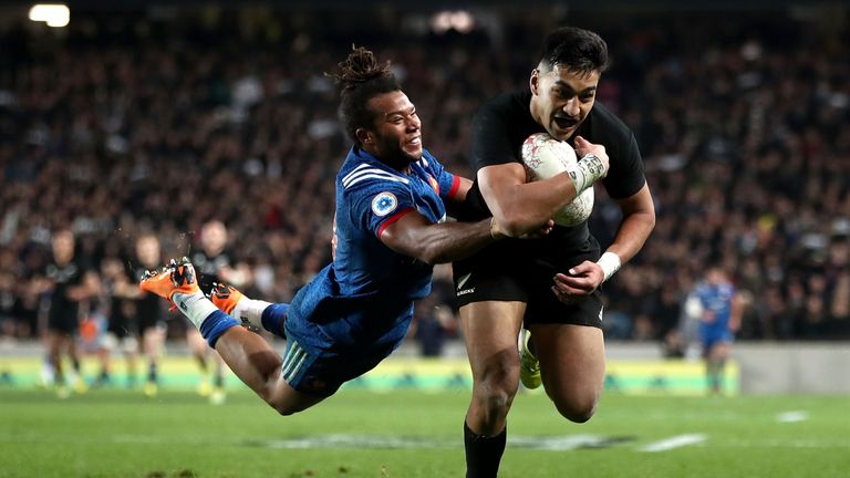 Rieko Ioane of the All Blacks scores a try despite the attentions of Teddy Thomas