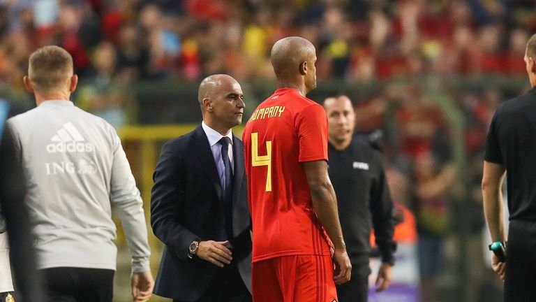 Roberto Martinez (C) speaks with Vincent Kompany as he leaves the pitch