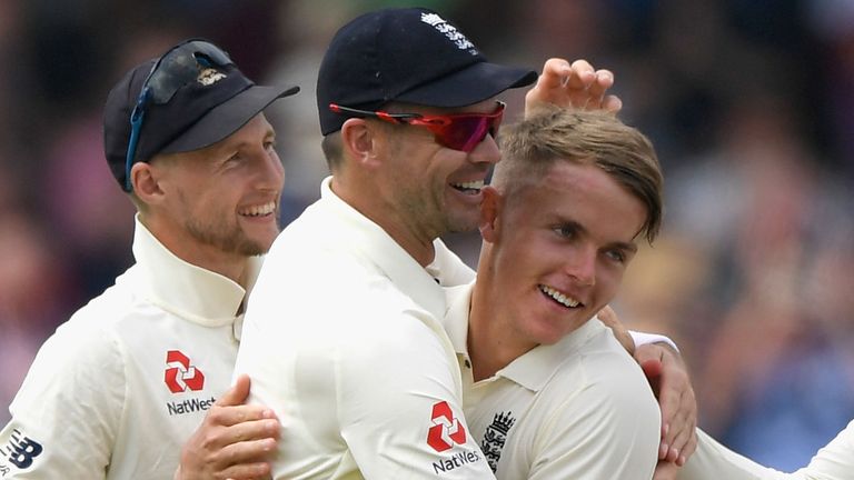 Sam Curran is congratulated by Joe Root and James Anderson after taking is first Test wicket
