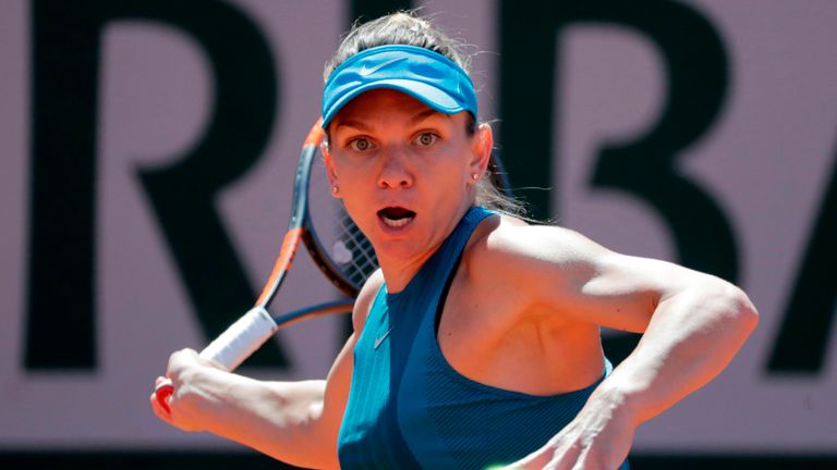 Romania's Simona Halep plays a forehand return to Spain's Garbine Muguruza during their women's singles semi-final match on day twelve of The Roland Garros 2018 French Open tennis tournament in Paris on June 7, 2018