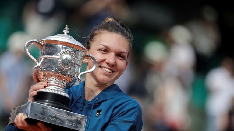 Romania's Simona Halep poses with her trophy, after winning the women's singles final match against Sloane Stephens of the US, on day fourteen of The Roland Garros 2018 French Open tennis tournament in Paris on June 9, 2018. 