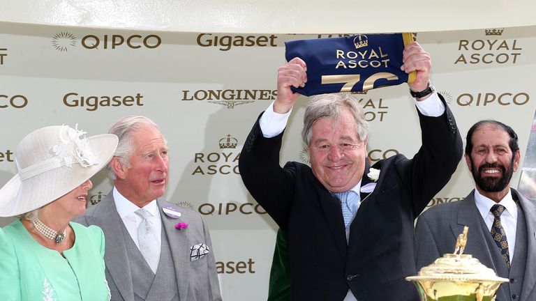 Sir Michael Stoute holds up a pennant marking his 75th victory at Royal Ascot after Poet's Word wins