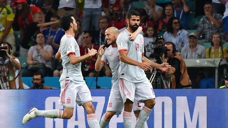 Spain forward Diego Costa (R) celebrates a goal with David Silva (C) and Sergio Busquets during the Russia 2018 World Cup Group B football match between Portugal and Spain at the Fisht Stadium in Sochi on June 15, 2018