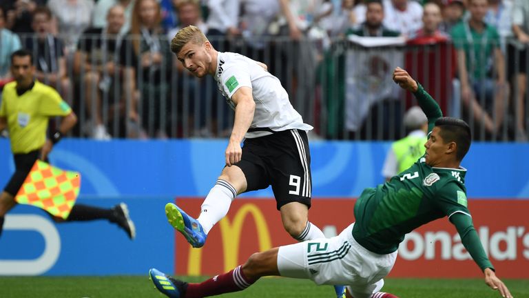 Timo Werner takes a shot on goal as Hugo Ayala attempts to block
