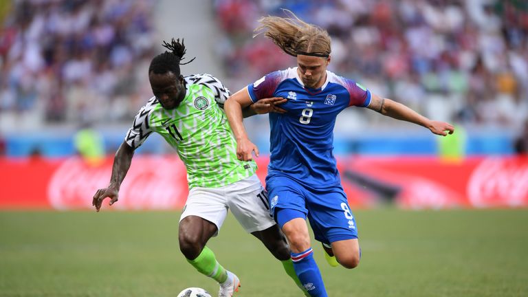 Victor Moses battles for possession with Birkir Bjarnason