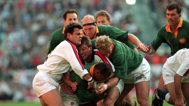 England's Will Carling and Rob Andrew attempt to shackle South Africa's Chester Williams during their clash in Cape Town in 1994