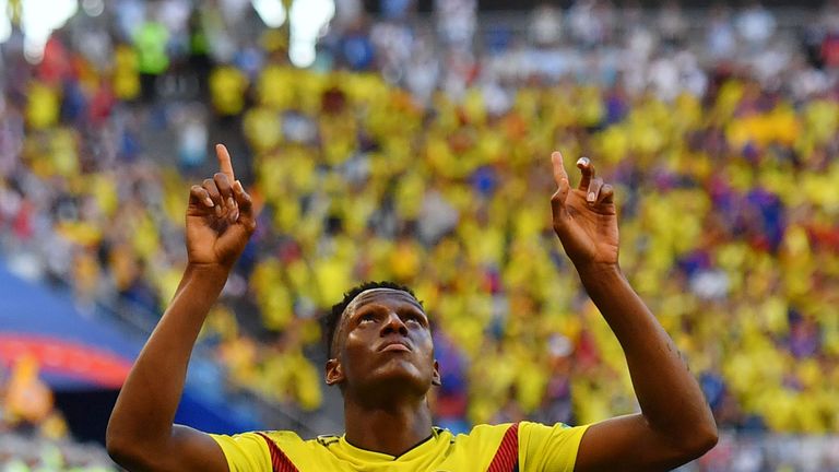 Yerry Mina celebrates after scoring the goal that sent Colombia through to the knockout stage of the World Cup