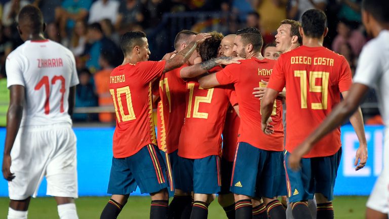 Spanish players celebrate the opening goal against Switzerland