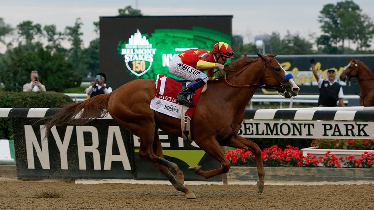 ELMONT, NY - JUNE 09:  Justify #1, ridden by jockey Mike Smith leads the field to the finish line to win the 150th running of the Belmont Stakes at Belmont Park on June 9, 2018 in Elmont, New York.  Justify becomes the thirteenth Triple Crown winner and the first since American Pharoah in 2015. (Photo by Michael Reaves/Getty Images)