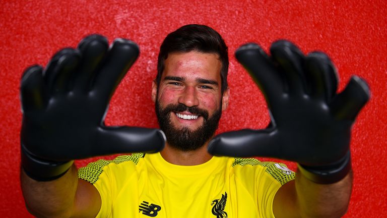 Alisson poses for photographs at Melwood after signing for Liverpool on July 19, 2018