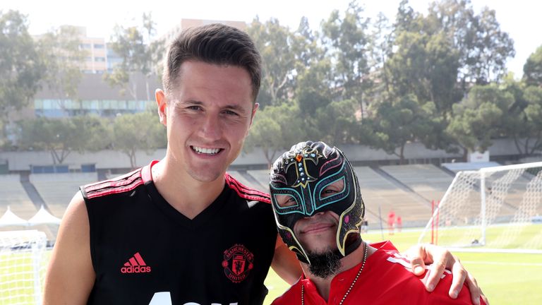 Manchester United's Ander Herrera poses with wrestler Rey Mysterio during a pre-season training session at UCLA on July 26, 2018