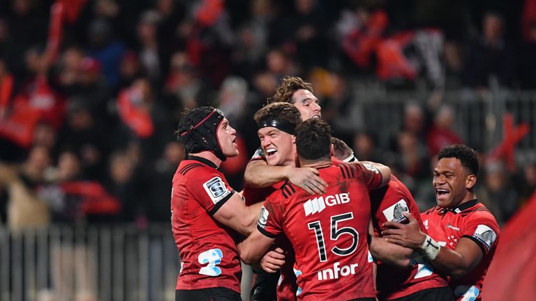 Scott Barrett is congratulated by team mates after scoring against the Highlanders