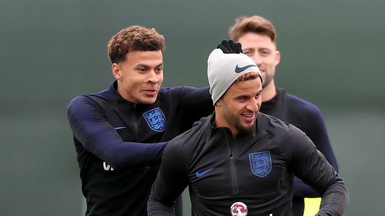 Dele Alli jokes with Kyle Walker during an England training session