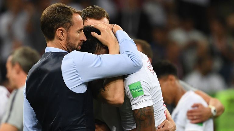 England's coach Gareth Southgate (L) embraces England's forward Marcus Rashford after the Russia 2018 World Cup semi-final football match between Croatia and England at the Luzhniki Stadium in Moscow on July 11, 2018