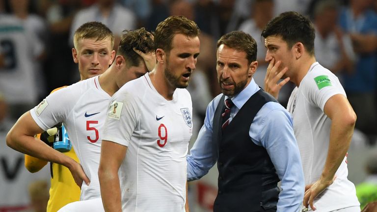 Gareth Southgate consoles England captain Harry Kane at the final whistle