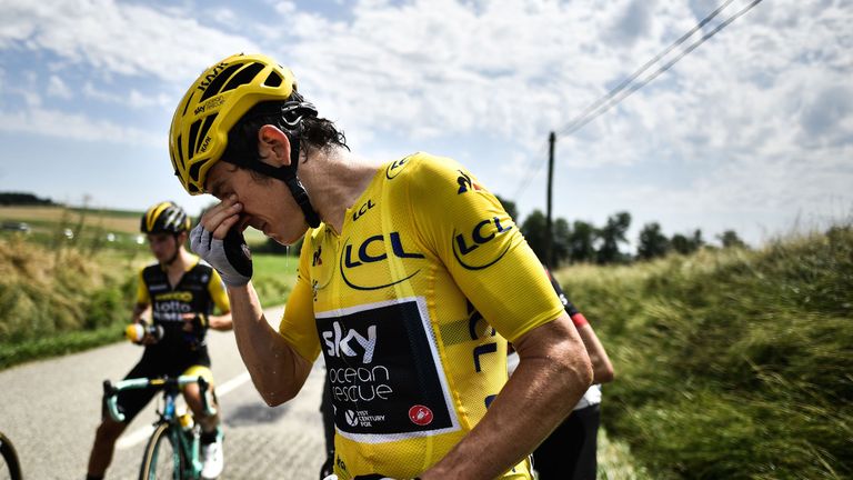 Great Britain's Geraint Thomas cleans his eyes after tear gas was used during a farmers' protest who attempted to block the stage's route