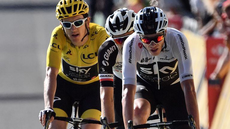 (From R) Christopher Froome, Tom Dumoulin and Geraint Thomas, wearing the overall leader's yellow jersey, cross the finish line of the 14th stage