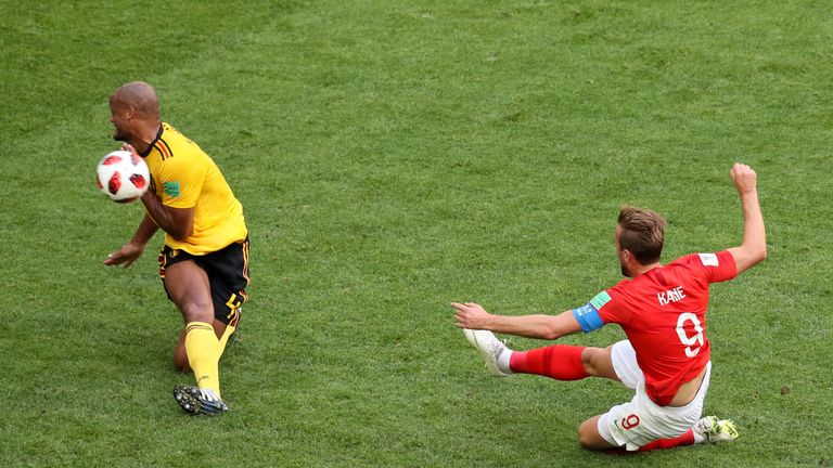 Harry Kane drags a shot wide under pressure from Vincent Kompany