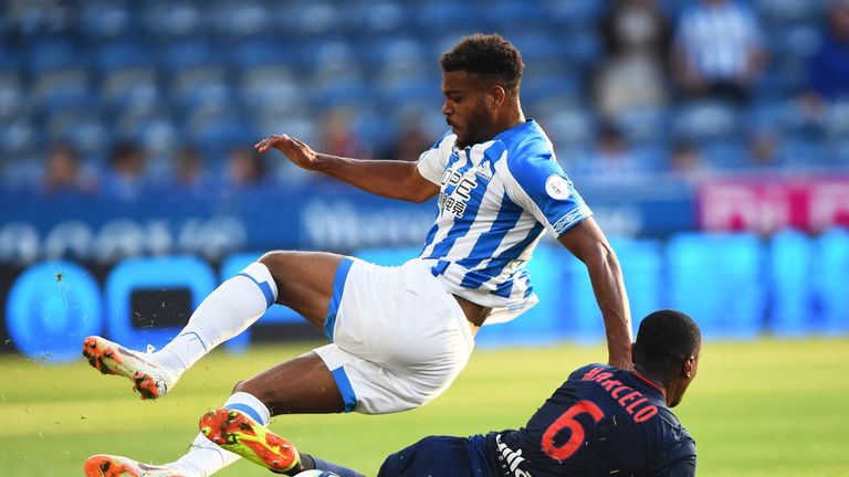 Steve Mounie of Huddersfield jumps a tackle against Lyon