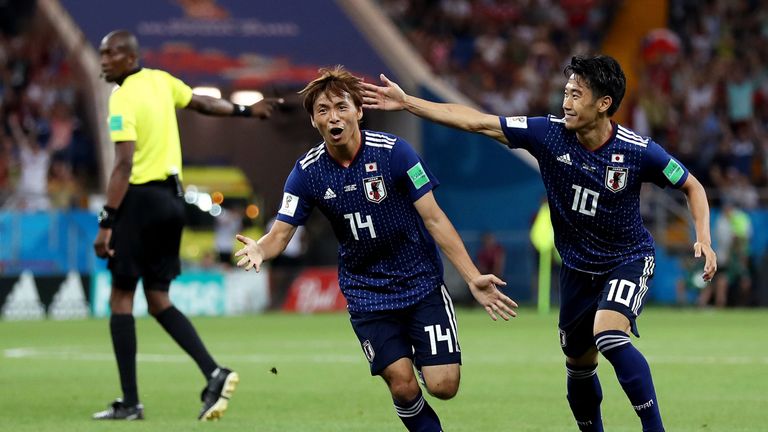 Takashi Inui celebrates doubling Japan's lead with a superb strike
