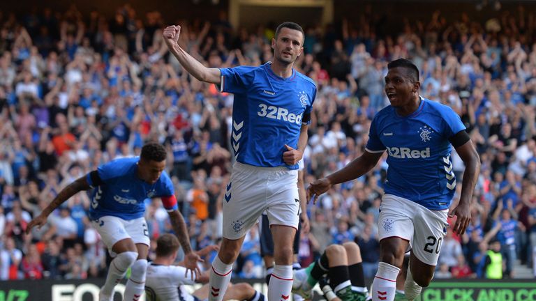 Jamie Murphy of Rangers is congratulated by his team mates after scoring the opening goal of the game 