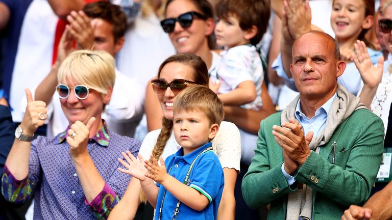 Jelena Djokovic (C), wife of Novak Djokovic of Serbia, and their son Stefan Djokovic applaud after the Men's Singles final on day thirteen of the Wimbledon Lawn Tennis Championships at All England Lawn Tennis and Croquet Club on July 15, 2018 in London, England. 