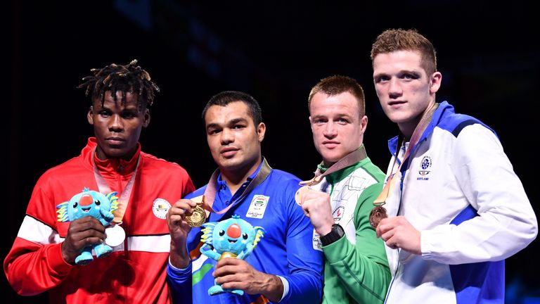 Silver medallist Cameroon's Dieudonne Wilfried Seyi Ntsengue, gold medallist India's Vikas Krishan and bronze medallists Northern Ireland's Steven Donnelly and Scotland's John Docherty pose during the medal ceremony for the men's 75kg boxing event during the 2018 Gold Coast Commonwealth Games 