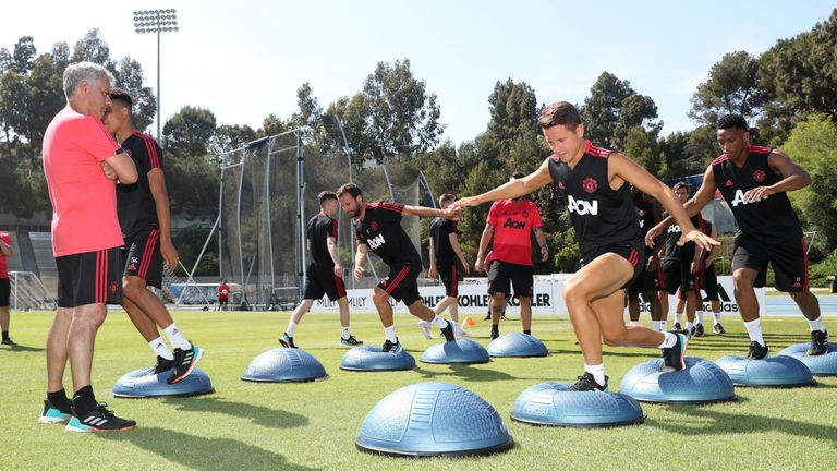 Jose Mourinho watches his Manchester United squad in their training session 